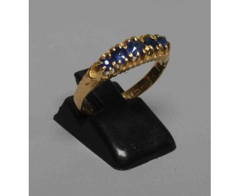 A MID VICTORIAN FIVE STONE SAPPHIRE RING, the graduated facet cut stones claw set to a plain 18ct gold shank, Birmingham no d