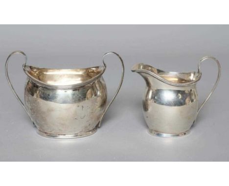 AN EDWARDIAN MILK JUG AND SUGAR BASIN by Charles Edward Nixon, Sheffield 1906, of plain oval bombe form with applied reeded r