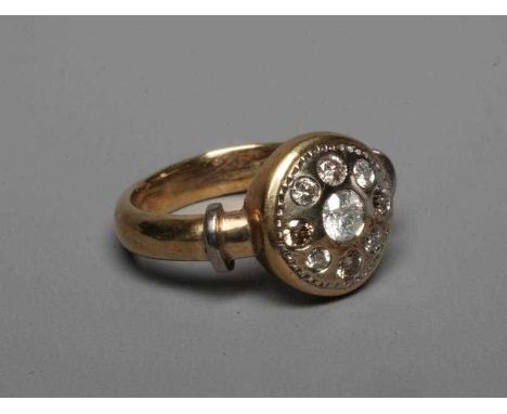 A DIAMOND DRESS RING, the circular boss panel centred by a brilliant cut stone of approximately 0.25cts to a border with four