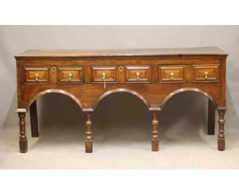 A JOINED OAK DRESSER of late 17th century design, possibly 19th century and assembled using old wood, the moulded edged plank