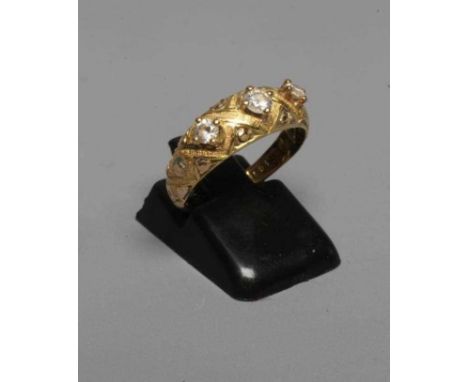 A MID VICTORIAN THREE STONE DIAMOND RING, the old cut stones point set to a lattice chased mount and shoulders on plain 18ct 