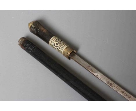A SWORD STICK, early 20th century, the 23 1/4" blade released with twist ferrule, carved bone and horn grip, lion pommel and 