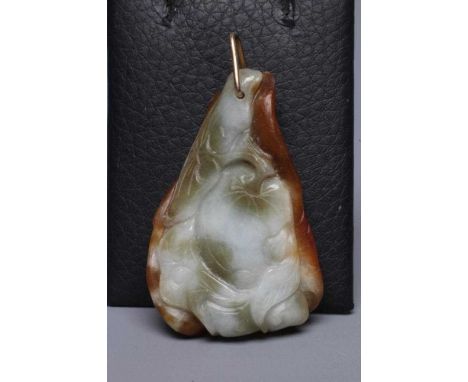 A CHINESE JADE PENDANT, one side carved as a hare (?) beside a flower, the other with a persimmon, unmarked triangular bale (