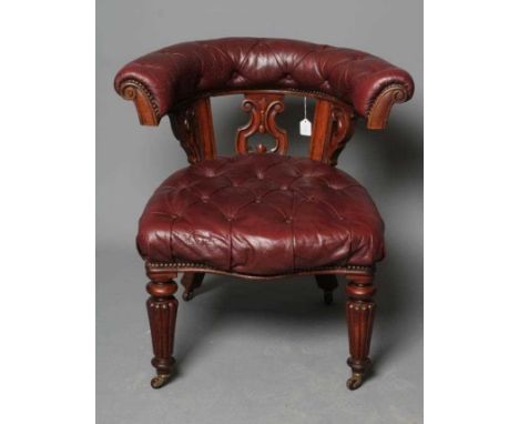 A VICTORIAN MAHOGANY CLUB LIBRARY CHAIR, third quarter 19th century, of tub form, button upholstered in red leather, the padd