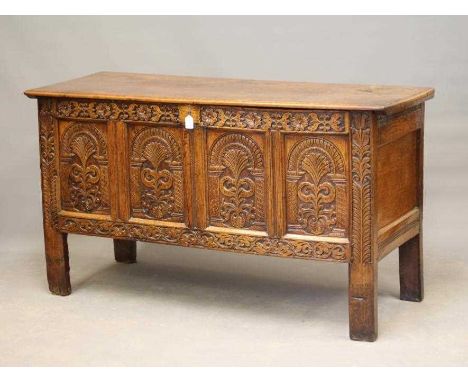 A JOINED OAK PANELLED CHEST, late 17th century and later, the hinged plank lid opening to a void interior, the fascia with fo