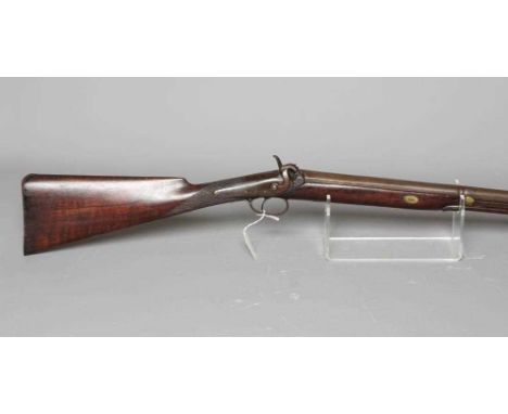 A PERCUSSION FOWLING GUN, the 32 1/4" barrel hexagonal at the breech, foliate etched action, walnut stock and wood ram, 49 1/