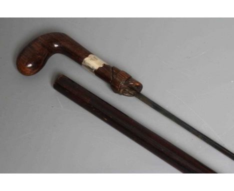 A SILVER MOUNTED SWORD STICK, Chester 1922, with 24 1/2" blued blade and buckle carved wood grip, 36 1/4" long (Est. plus 24%