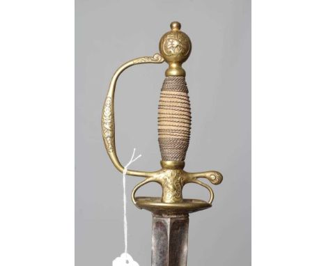 A BRASS HILTED SMALL SWORD, the 33 1/2" triangular section rapier blade etched with stars amid scroll work, hilt with shell g