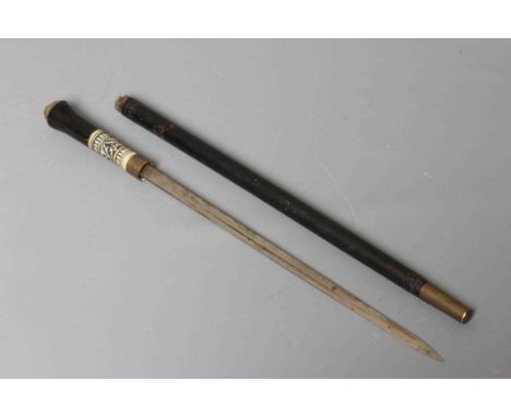 A SWAGGER SWORD STICK with 13 3/4" twist release ferrule, carved bone section to grip and lion pommel, 22 3/4" long (Est. plu