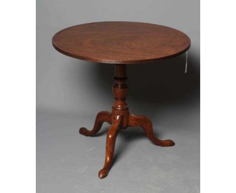 A GEORGIAN MAHOGANY TRIPOD TABLE, third quarter 18th century and later, the circular tilt top with reeded edge raised on turn