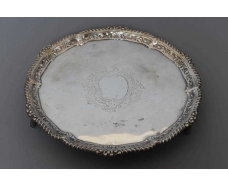 A LATE VICTORIAN SALVER by and retailed by Gibson of Belfast, London 1900, of shaped circular form with gadrooned rim enclosi