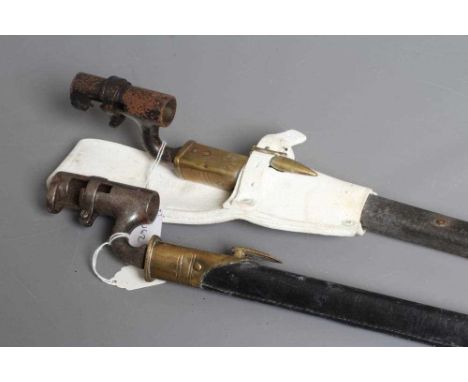 TWO BRITISH PATTERN SOCKET BAYONETS, both with triangular section blades, brass and leather scabbards and one with a white le