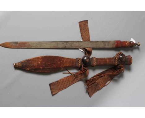 A NORTH AFRICAN SWORD with 29 1/4" triple fullered blade, leather grip with plaited reed decoration and brass pommel, leather