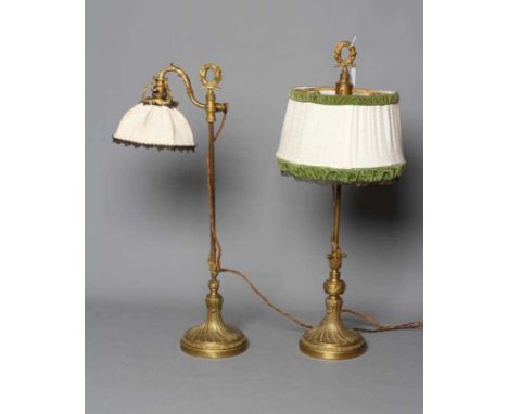 A BRASS LIBRARY LAMP, early 20th century, with embossed classical and foliate decoration, 28" high, together with a similar l