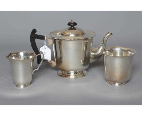 AN EDWARDIAN THREE PIECE TEA SERVICE by Lee &amp; Wigfull, Sheffield 1911, of plain U form with everted wavy rim, comprising 
