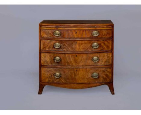 A GEORGIAN MAHOGANY BOW FRONT CHEST, c.1800, the banded caddy top over a slide and four shallow drawers with oval brass handl