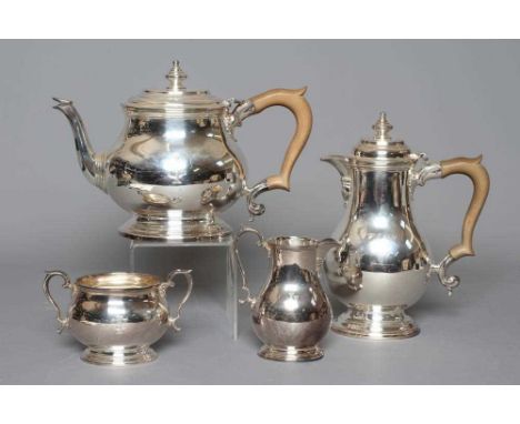 A FOUR PIECE TEA SERVICE by Atkin Brothers, Sheffield 1954, of oval baluster form on low spreading bases, engraved with a mon