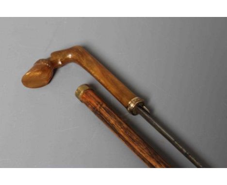 A LATE VICTORIAN SWORD STICK with a button released 26" flat section blade, horn grip carved as a hoof and bamboo shaft, 35 1