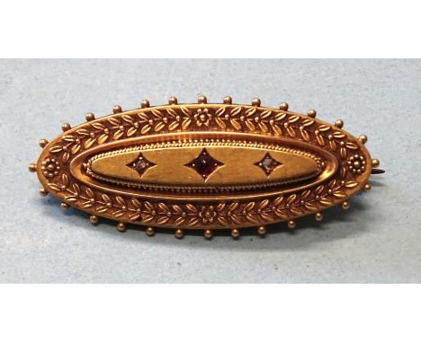 A Victorian 15ct gold locket-back brooch of marquise form, set a ruby and two rose-cut diamond points, 43mm, 5.2g.