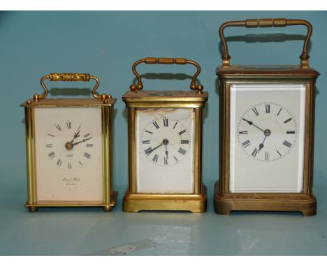 A brass carriage clock, striking on a gong, 13cm, a smaller brass carriage clock, 11cm high and a modern carriage clock, (all
