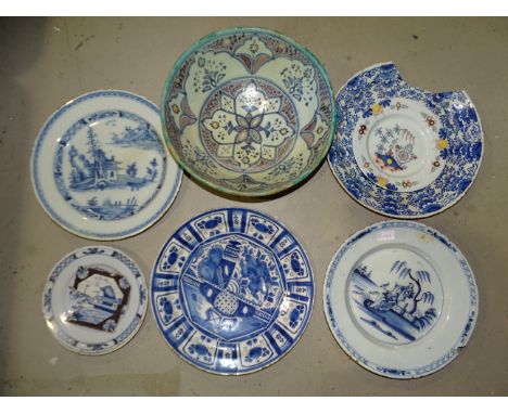 An 18th century Delft charger depicting a courting couple, 34cm diameter, (large chip to rim, an old repair) and other 18th a