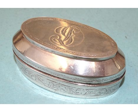 An unmarked Continental oval shape white metal two-division snuff box, with double lid and engraved banded decoration, (damag