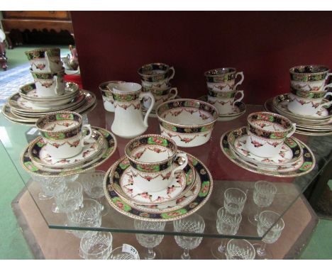 An Edwardian 12 place tea set, white ground with deep blue / green / gilt borders and rose garland swags 