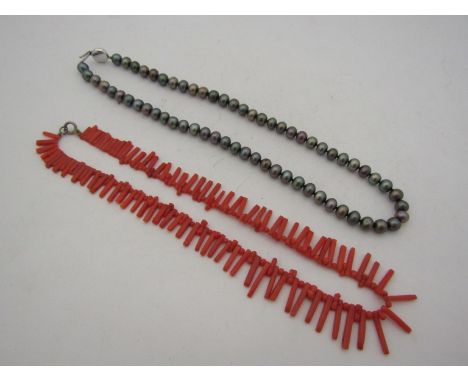 A coral necklace and a single strand bronze pearl necklace    
