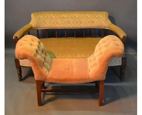 A Late Victorian Walnut Sofa With A Spindle Back above a stuff over seat, raised upon turned legs, together with an upholster