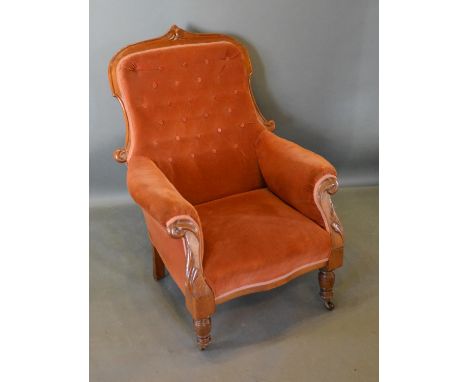 A William IV Mahogany Library Armchair with a button upholstered back above an over stuffed seat with scroll arms raised upon