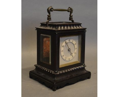 An Ebonized Small Bracket Clock The Dial With Arabic Numerals, the movement with lever escapement and carrying handle, 17cm t