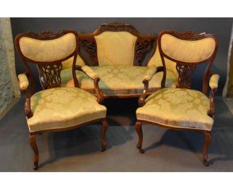 A Victorian Walnut Three Piece Drawing Room Suite, comprising sofa with two matching armchairs, all with partly upholstered a