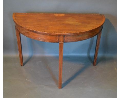 A 19th Century Mahogany Demilune Console Table, the shell inlaid and cross banded top above a similar frieze, raised upon squ