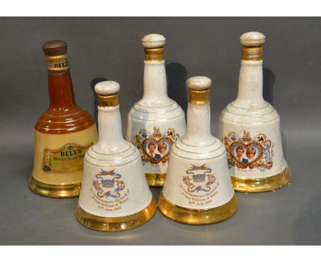 A Bells Scotch Whiskey Decanter In The Form Of A Commemorative Bell, together with four other similar decanters 