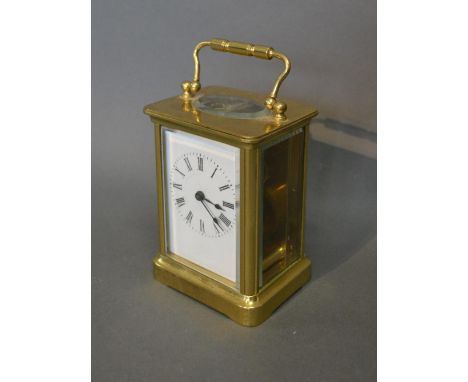A French Brass Cased Carriage Clock The Enamel Dial with Roman numerals with lever escapement and carrying handle 