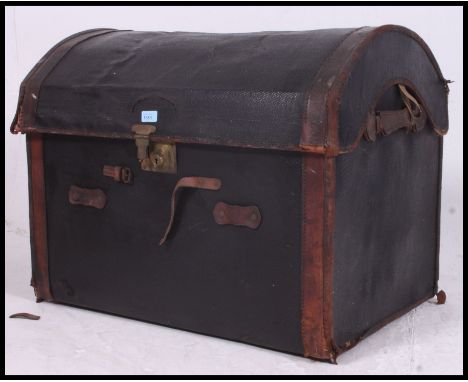 A vintage tan leather and canvas dome top trunk, c1900, brass clasp to front. H61 x W79 x D55cm
