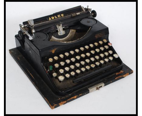 A vintage cased early 20th century reporters typewriter by Adler of Frankfurt. W28cm 