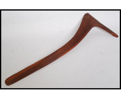 An Australian Aboriginal  wooden hunting stick, aka killing stick, the curved heavy object with grooved carving to one side a
