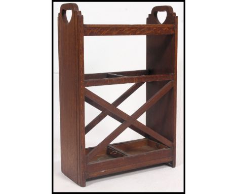 A Victorian Arts & Crafts oak stick - umbrella hall stand. The squared supports with drip trays to base having x-stretchers t
