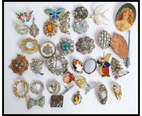 A large collection of costume jewellery brooches to include mid century. Seagull, enamel set, cameo pictorial, celtic, stone 