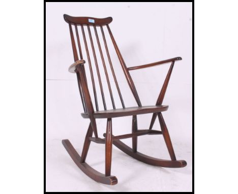 A vintage Ercol beech and elm Windsor rocking chair - armchair. Sleigh runners with turned legs, panel seat and railed back r