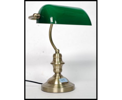 A 20th century contemporary antique style brass effect bankers desk top lamp with angular green glass shade