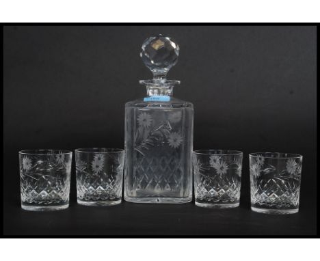 A good quality cut glass and etched decorated decanter together with 4 matching whisky tumblers