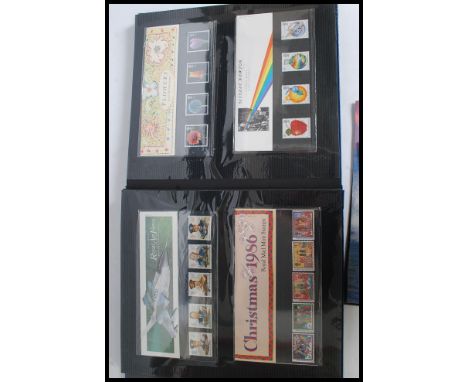 A stamp album containing several unused / franked Royal Mail postage stamps / first day covers ( approx face value +£40 ) alo