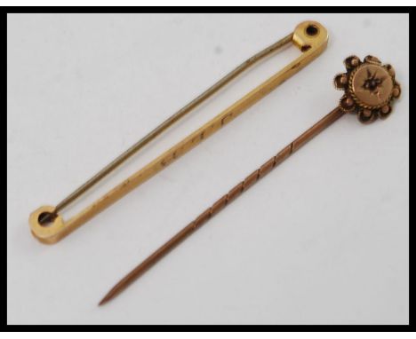 An gentlemans 9ct gold tie pin with monogram J.L.B. together with a 9ct gold and ruby garnet stone hat pin. Total combined we
