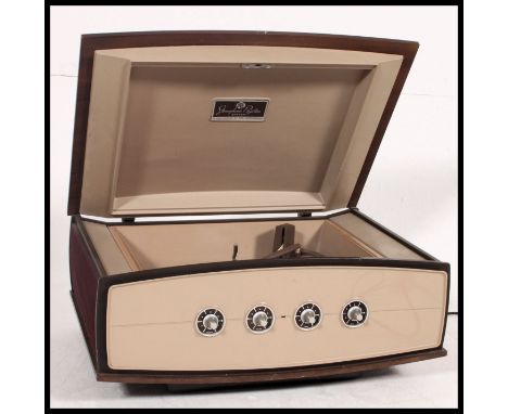 A retro PYE 1950's stereogram record player complete with instruction manual having space age facia and case with hinged top