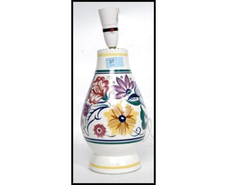 A vintage mid century Poole pottery ceramic table lamp, signed to the base with makers marks in a chint pattern with white gr