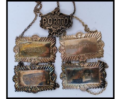 A collection of 5 silver plated decanter labels. To  include Sherry, Whisky, Vodka, Brandy & Porto