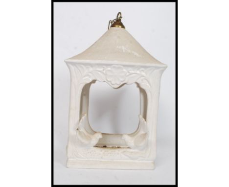 A large ceramic bird feeder of lantern shape embellished with birds to the sides having chain atop. H37cm 