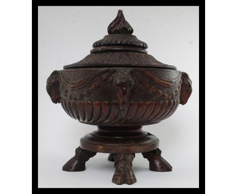 An unusual black forest carved wooden centrepiece / lidded fruit bowl. Raised on cloven hoof feet with carved details having 